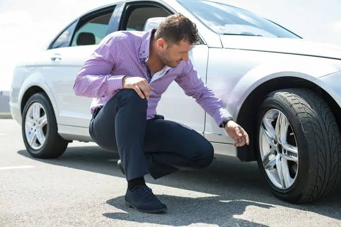 How do I handle a tire blowout while driving?